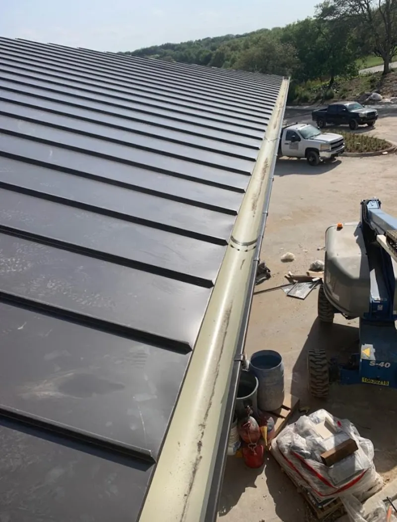 Standing seam panel and gutter detail on a metal roofing jobsite in Charlestown